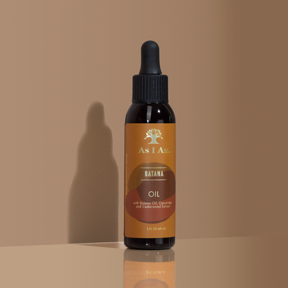 زجاجة من زيت As I Am batana على خلفية بيج